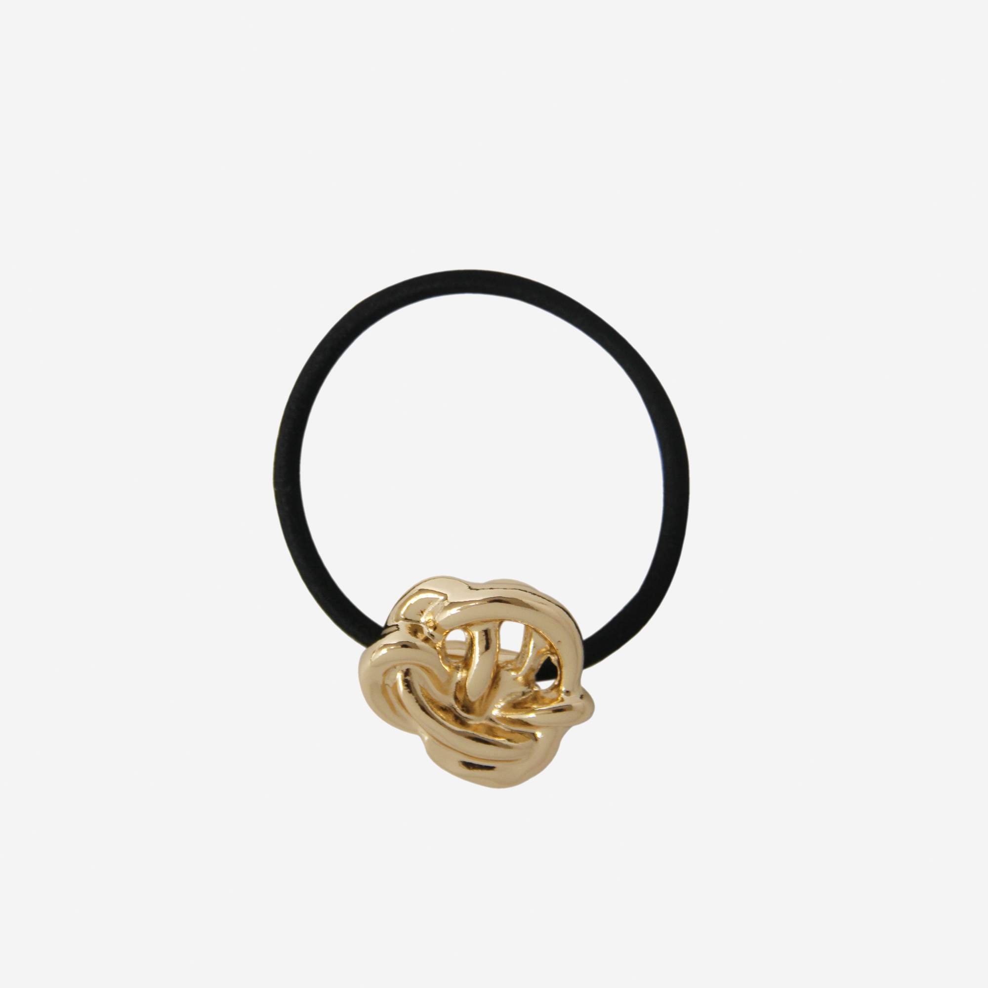 Black hair elastic with a gold knot detail, on an off white background