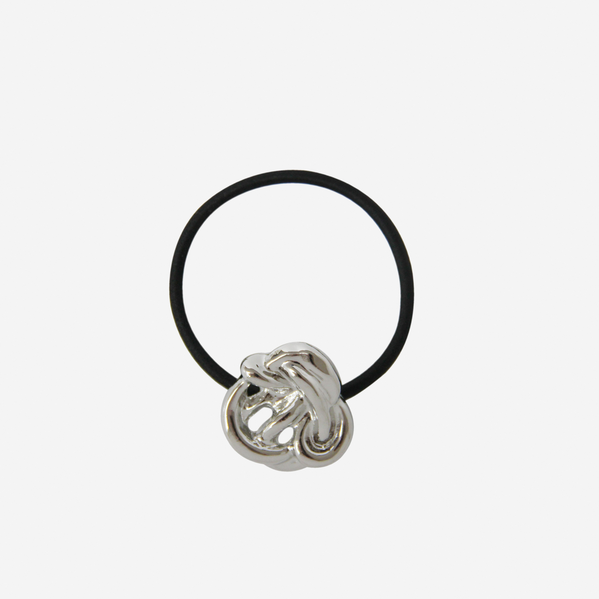 Black hair elastic with a silver knot detail, on an off white background
