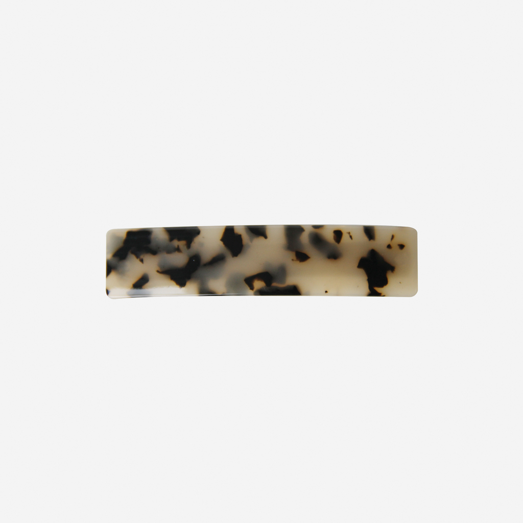 Light tortoiseshell hair barrette on an off white background