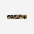 Light tortoiseshell hair barrette on an off white background