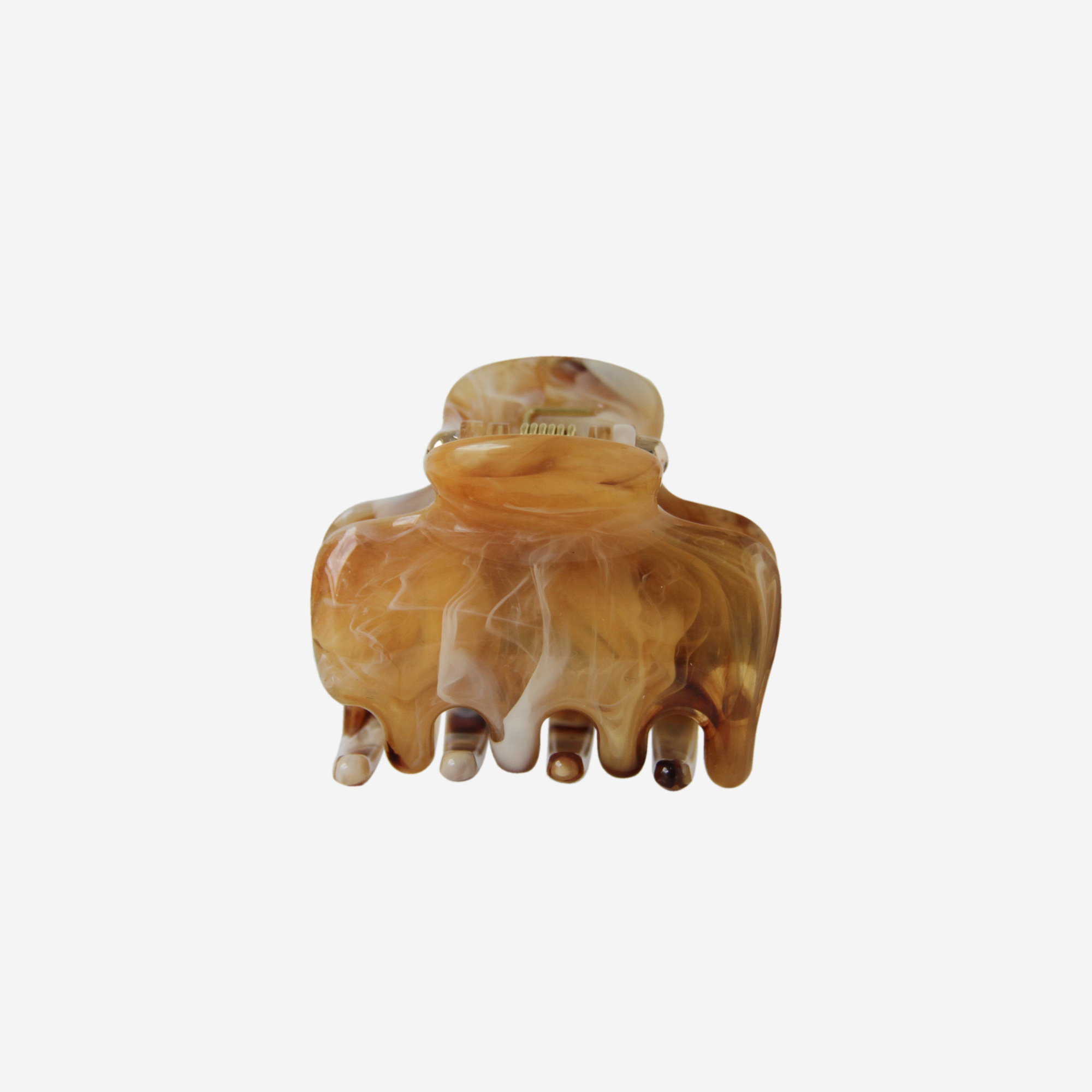 Brown and beige marble effect hair claw on an off white background