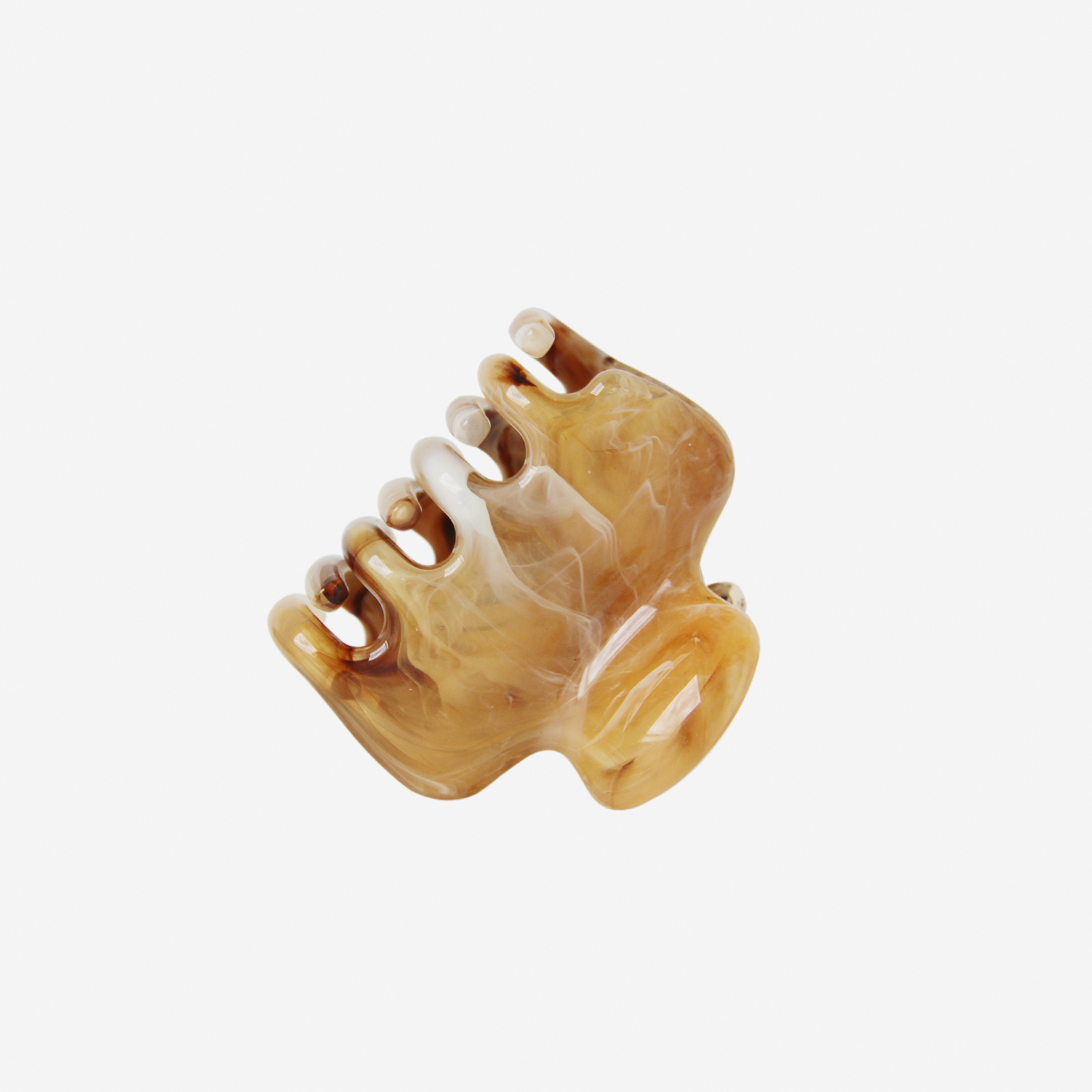 Brown and beige marble effect hair claw photographed on it's side on an off white background