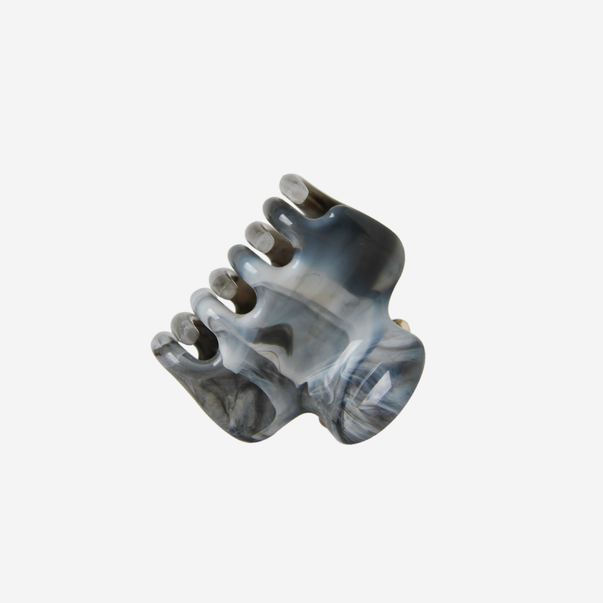 Blue, Black and Grey marble effect hair claw photographed on its side on an off white background