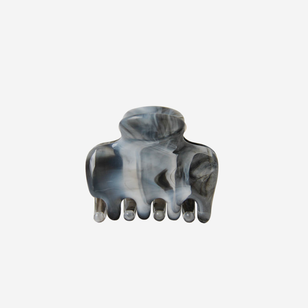 Blue, black and grey arble effect medium hair claw on an off white background