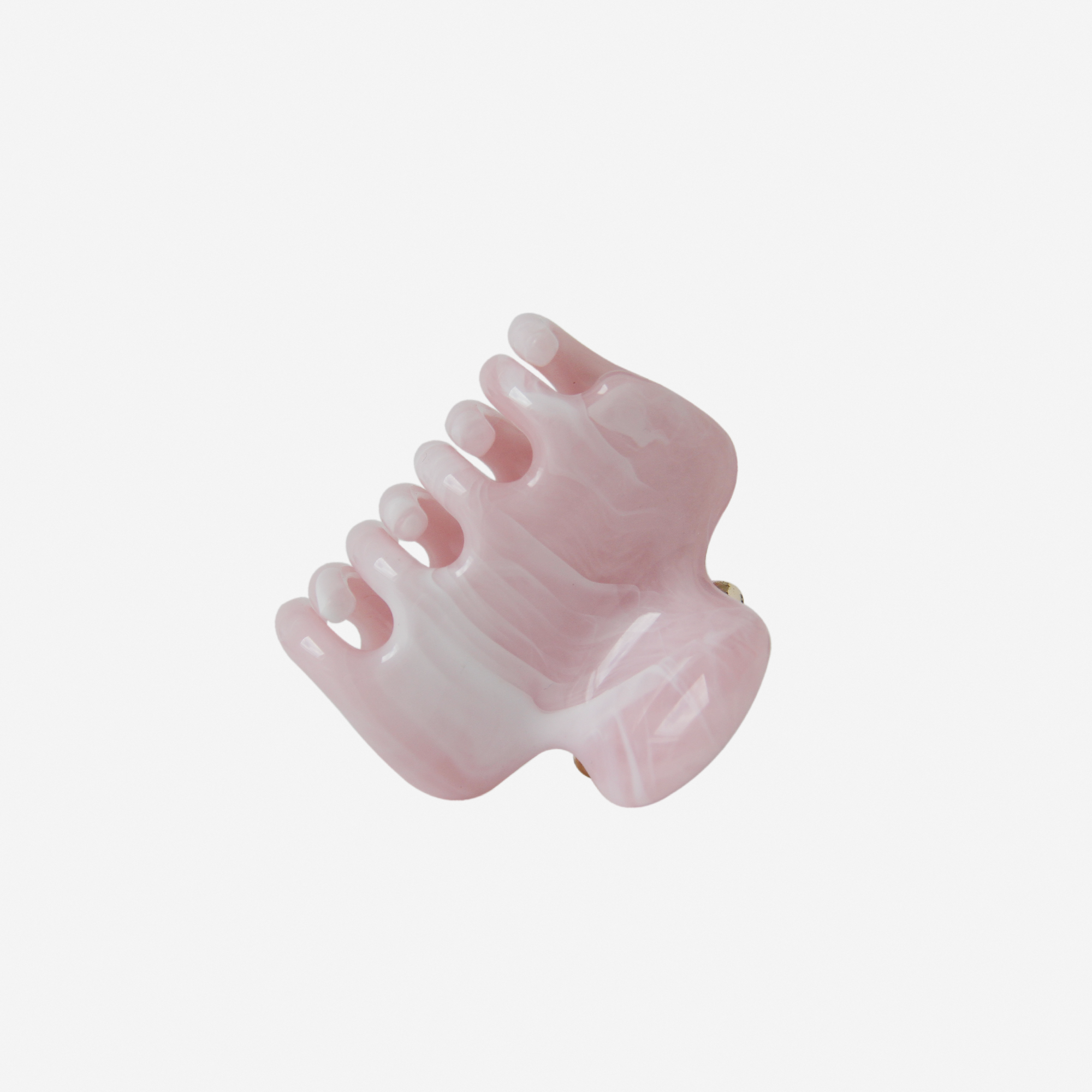 Pink marble medium hair claw photographed on it's side on an off white background