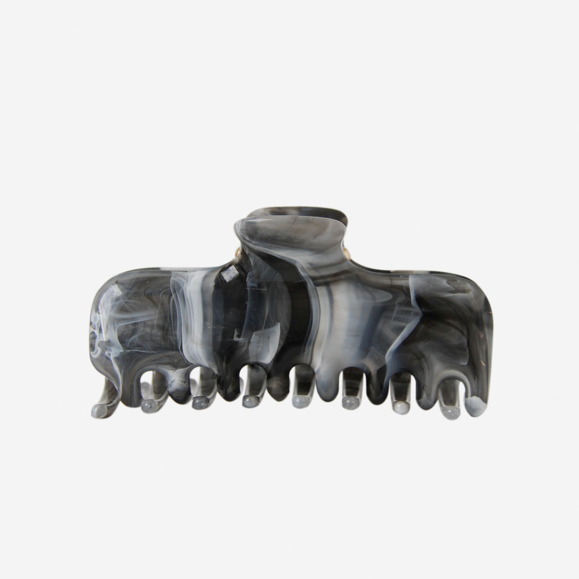 Grey, black and blue marbled hair claw on an off white background