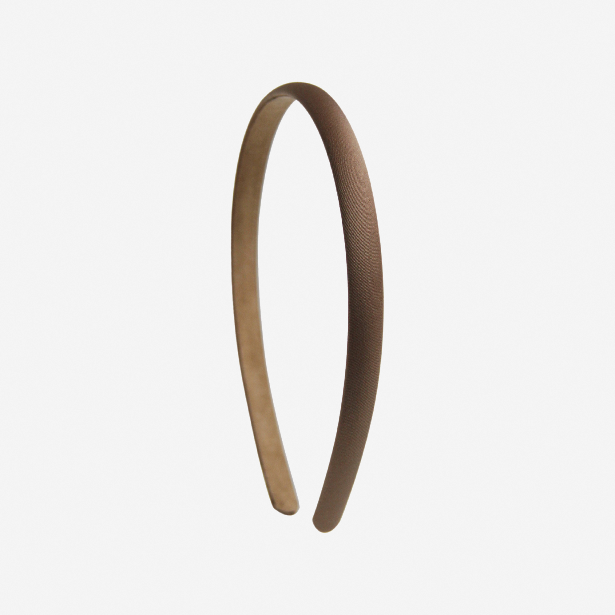 Narrow brown headband on an off white background