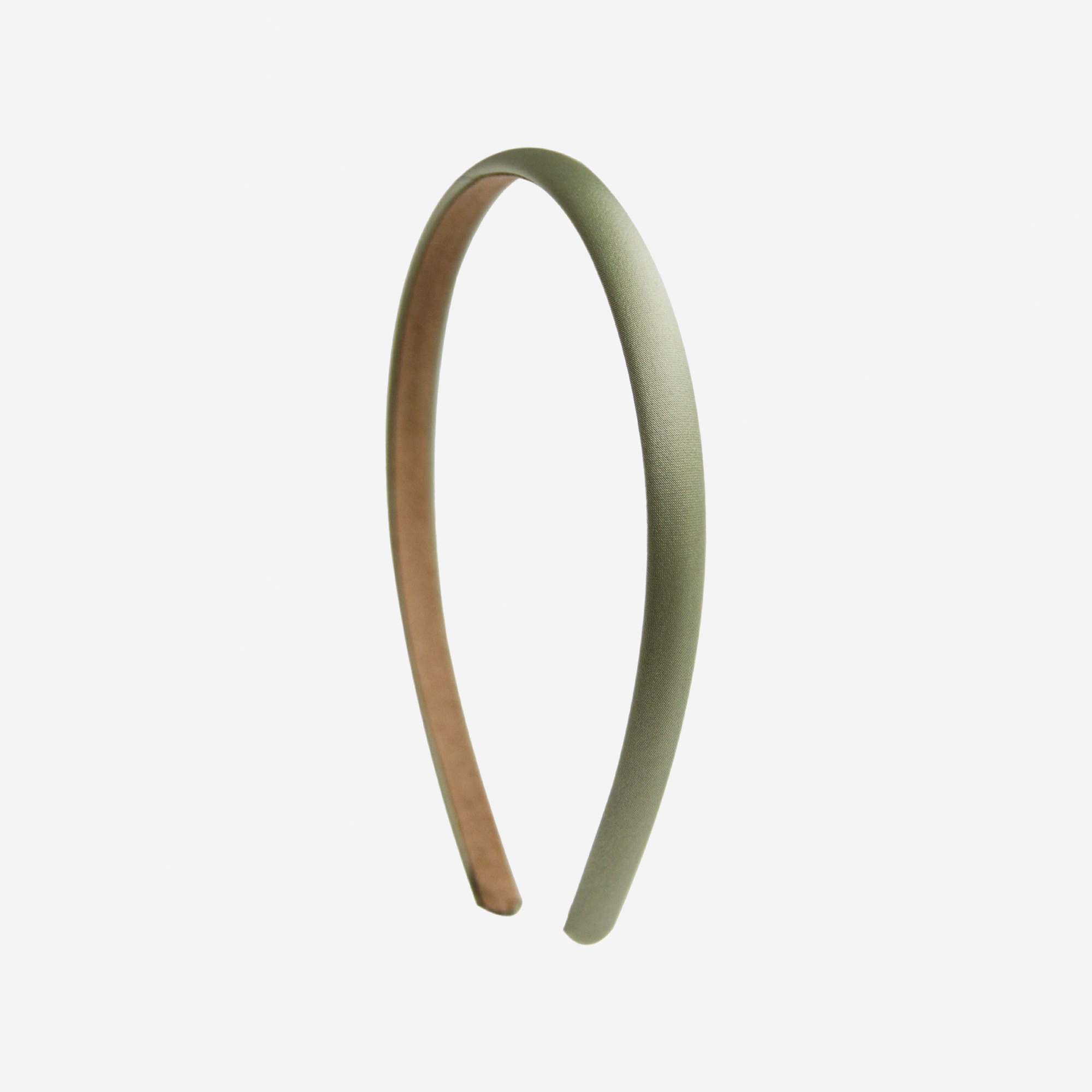 Narrow green headband on an off white background