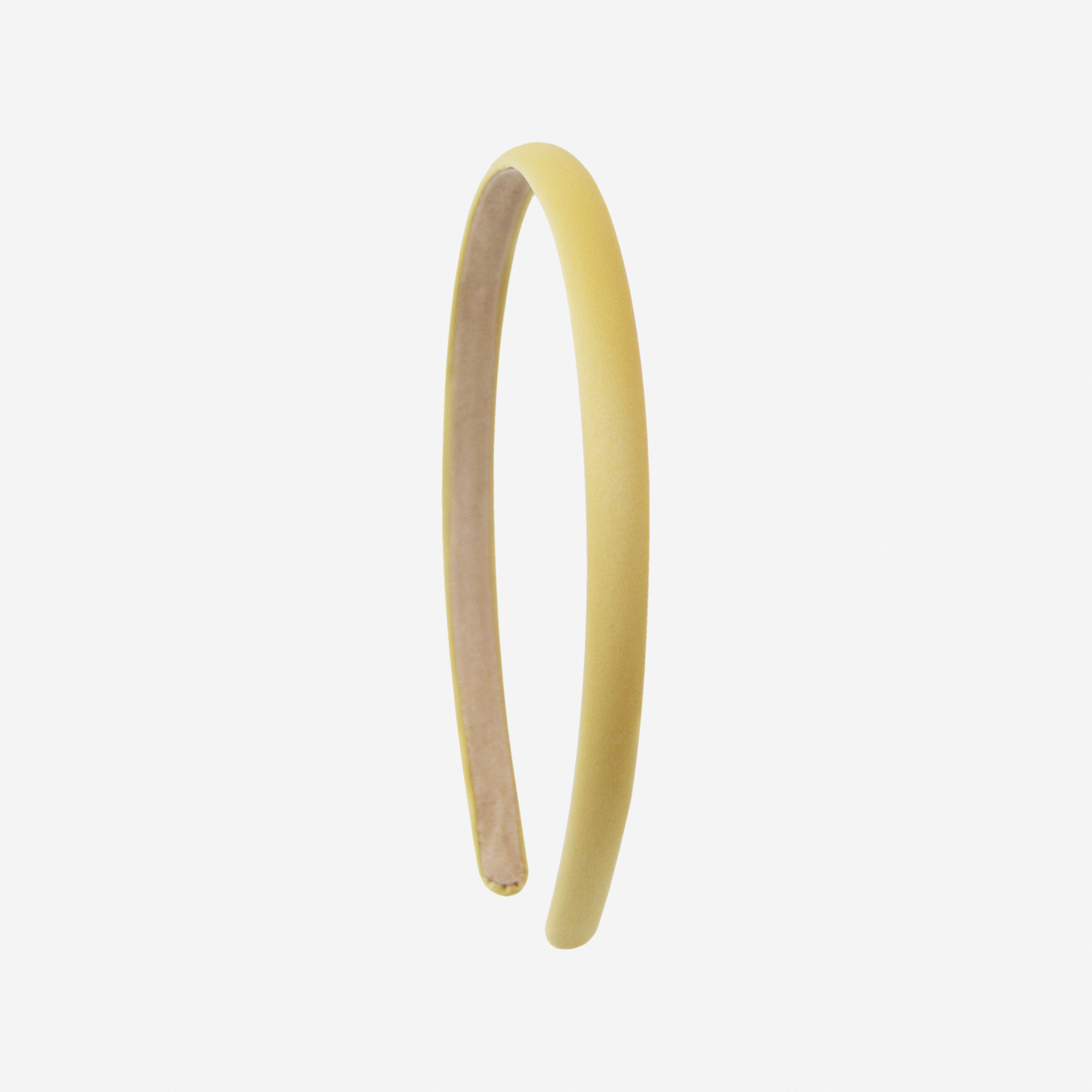 Narrow yellow headband on an off white background