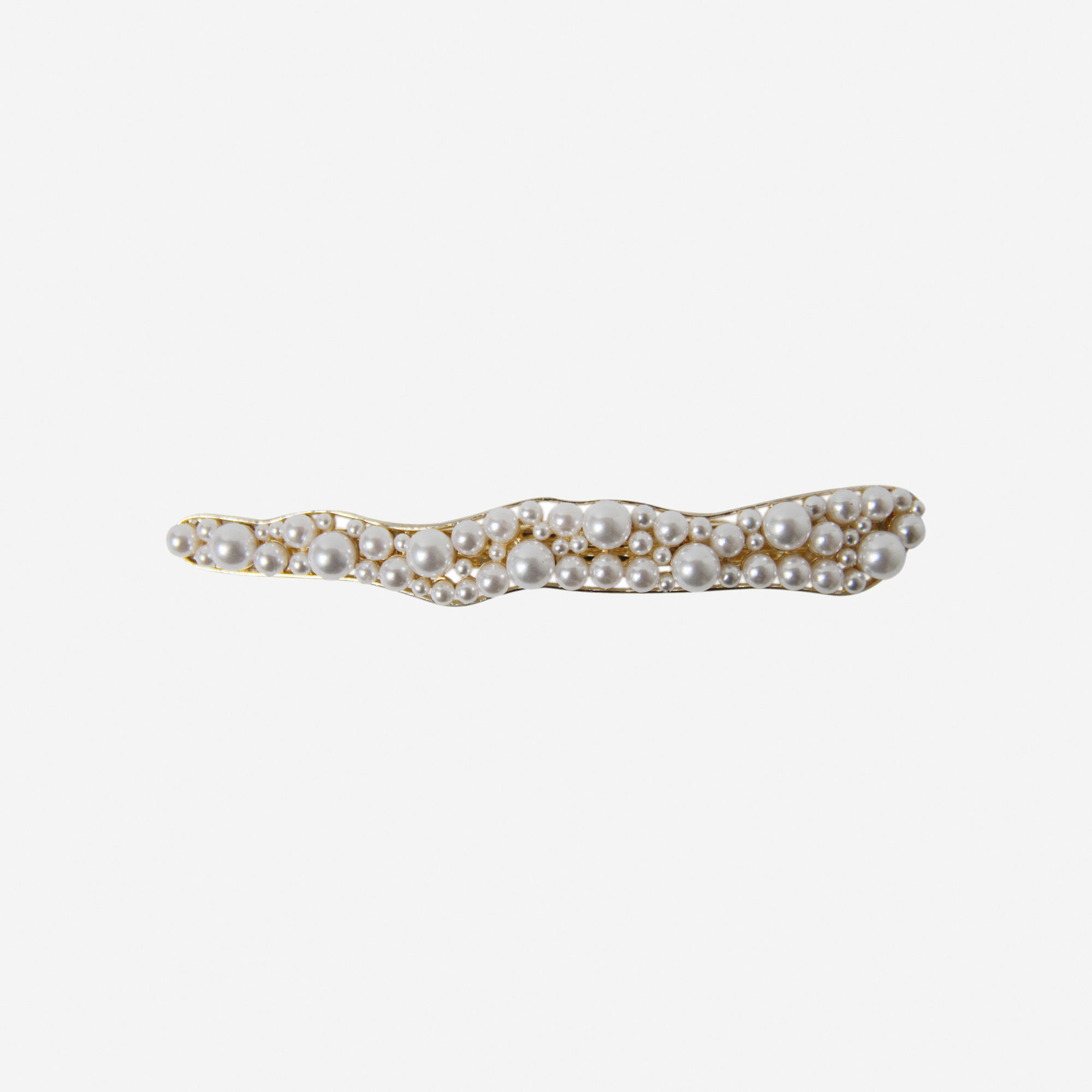 elongated pearl and gold hair clip with an organic shape on an off white background