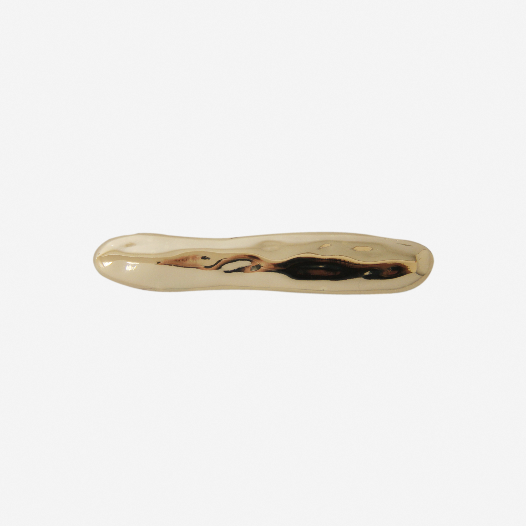 Gold hair clip with an organic shape on a white background
