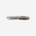 Silver hair clip with an organic shape on a white background