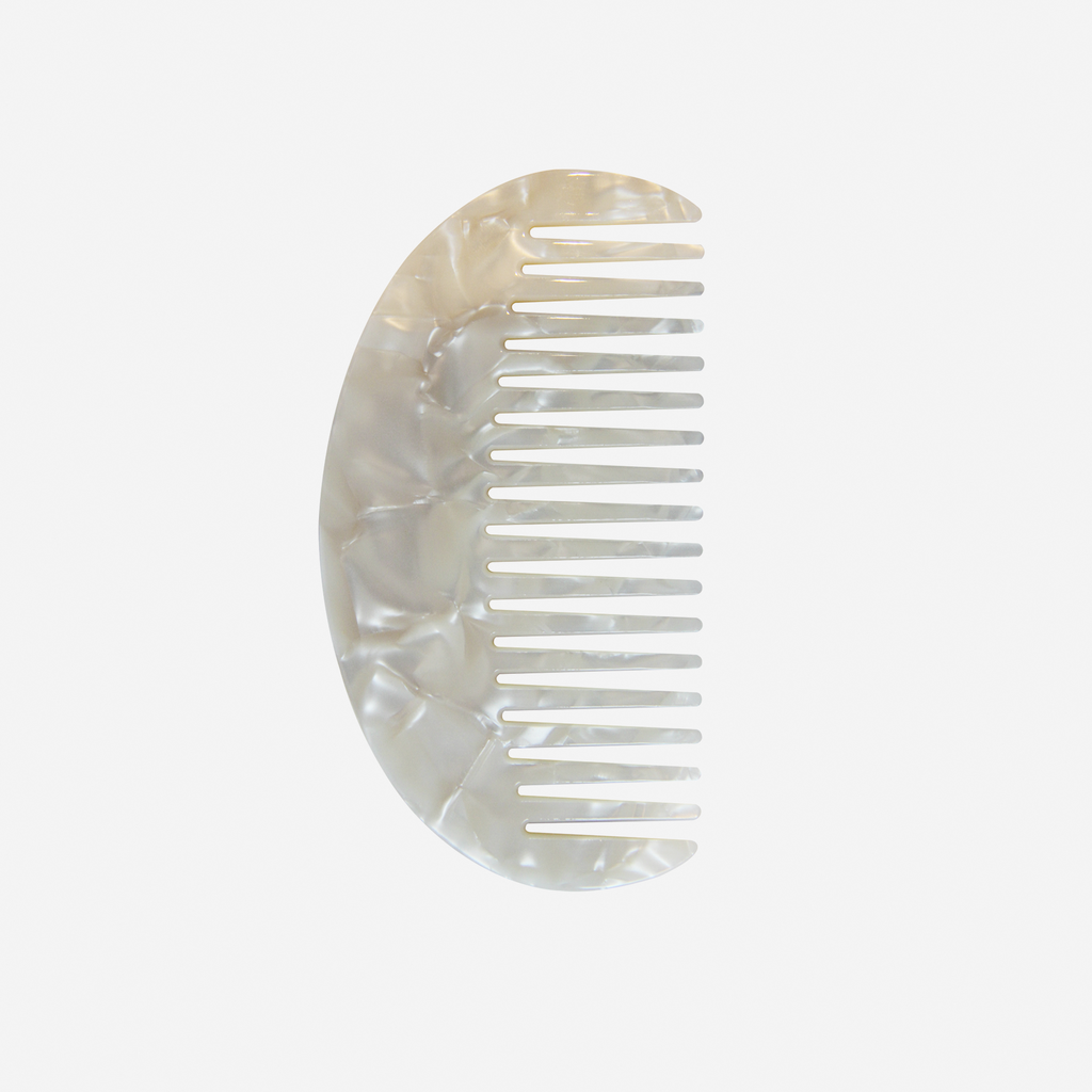 Oval mother of pearl wide tooth resin hair comb that's great for detangling and styling