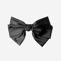 Large black hair bow on an off white background
