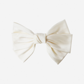Large cream hair bow on an off white background