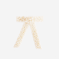 Pearl and cream velvet hair bow on an off white background