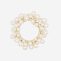 Pearl and crystal beaded hair tie on an off white background