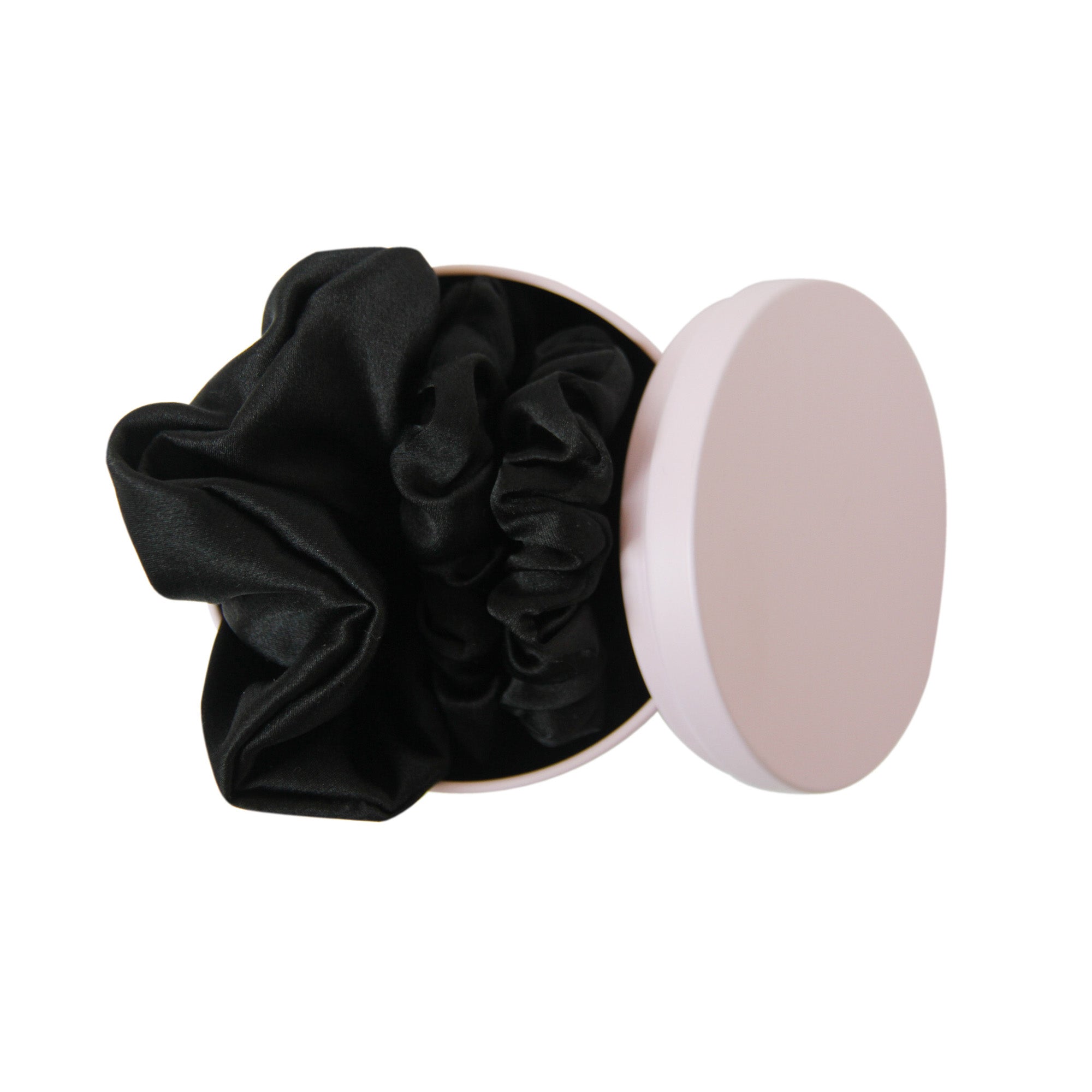 Pink Braid & Bow tin with three black silk scrunches on a white background