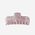 Pink and white marbled hair claw on a light gray background