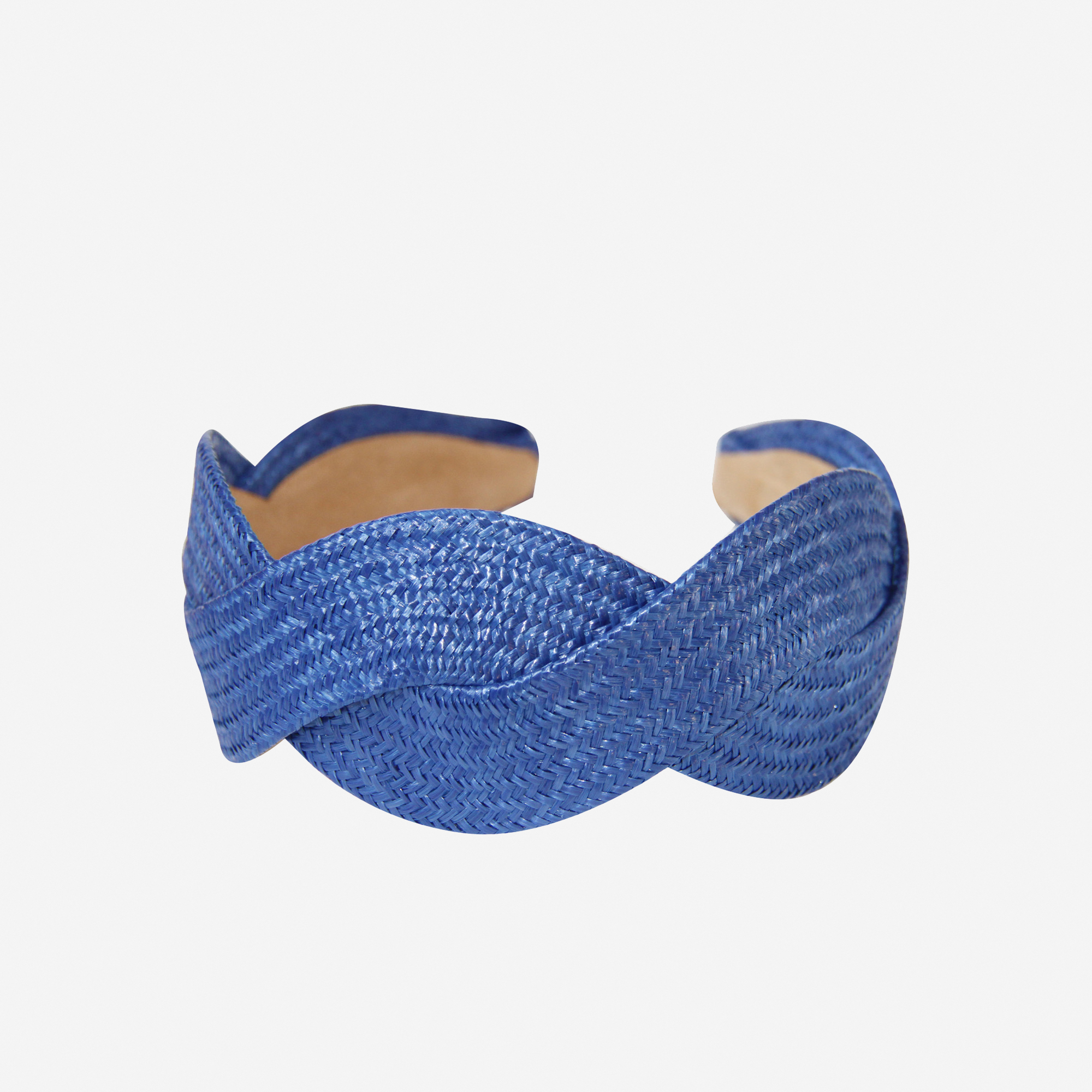 Woven blue raffia headband on an off white background