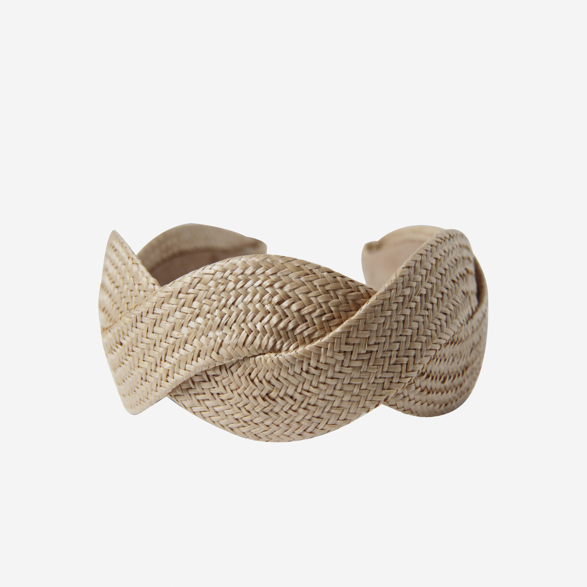 Woven raffia headband on an off white background