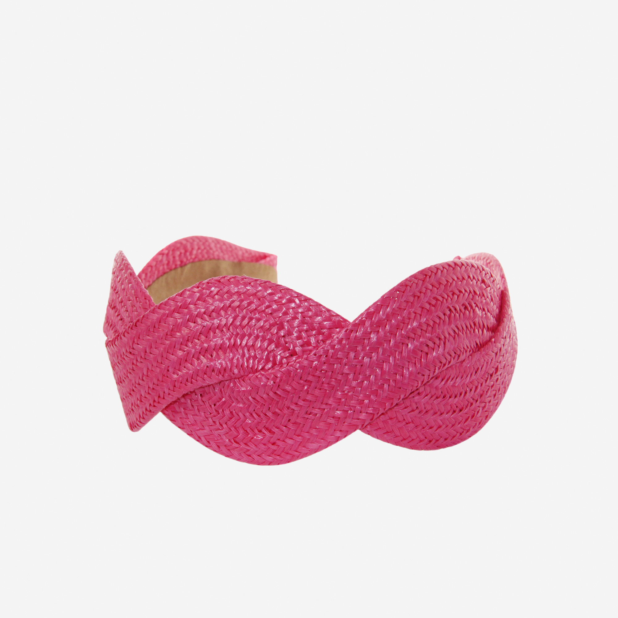 Woven pink raffia headband on an off white background