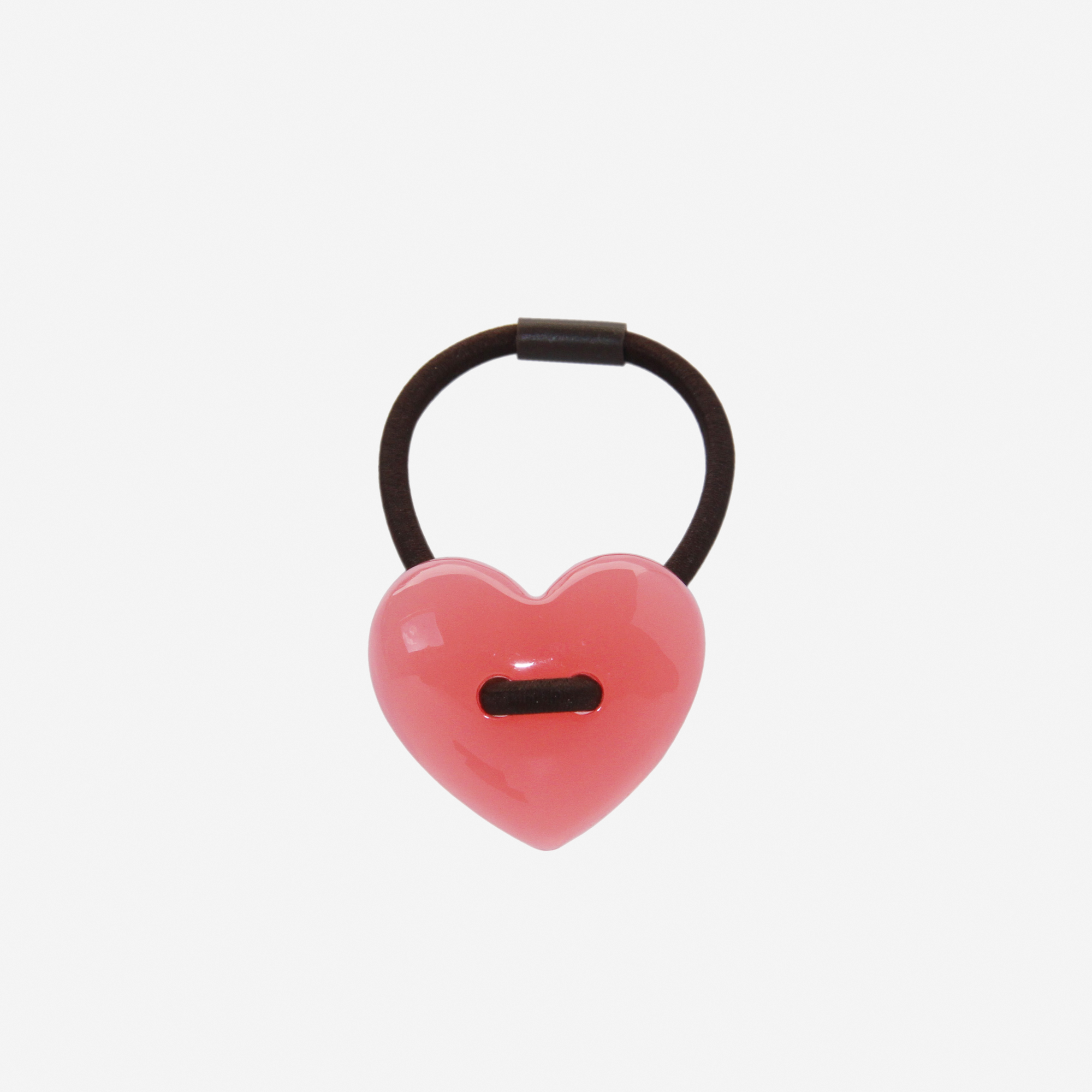 Pink heart shaped resin hair tie on an off white background