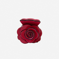 Crimson pink rose shaped hair claw on an off white background