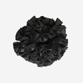 Black ruffle and frill scrunchie on an off white background