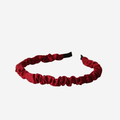 Narrow ruffle ruched red berry hairband on an off white background