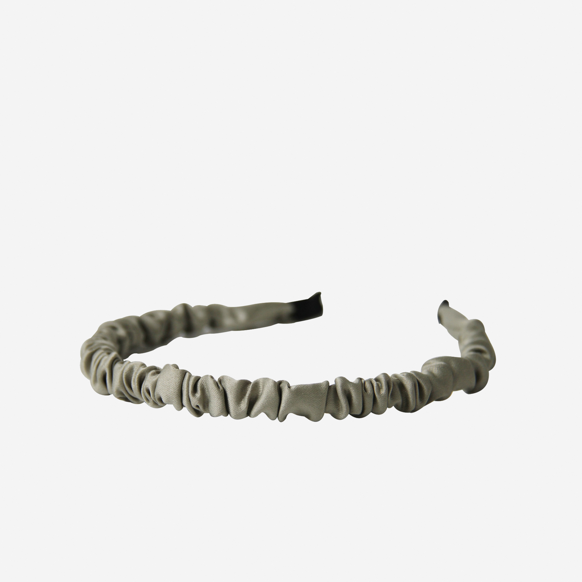 Narrow ruffle ruched sage green hairband on an off white background