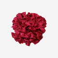 Red ruffle and frill scrunchie on an off white background