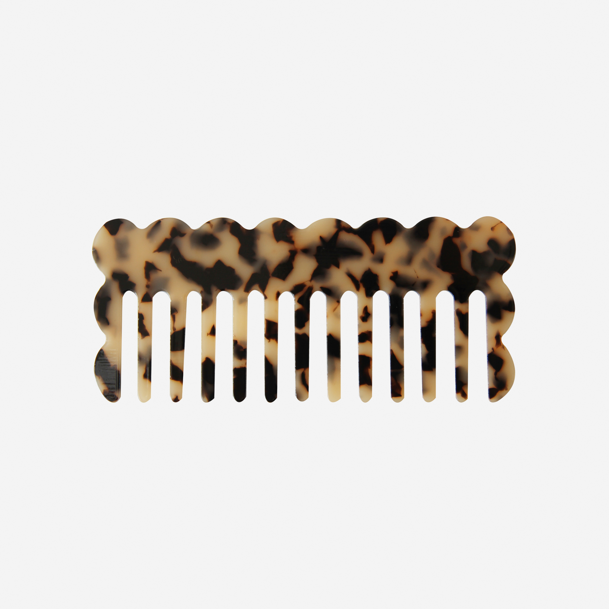 Scalloped light tortoiseshell wide tooth resin hair comb that's great for detangling and styling