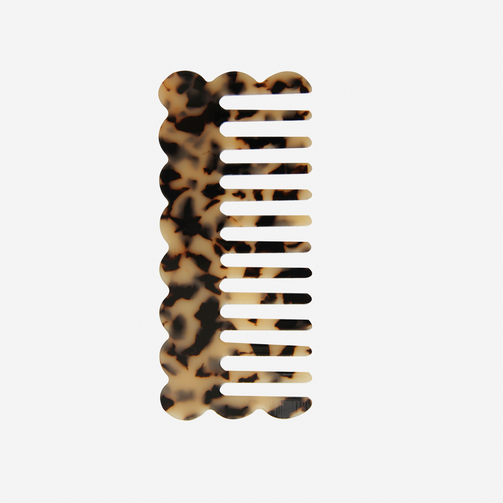 Scalloped light tortoiseshell wide tooth resin hair comb that's great for detangling and styling