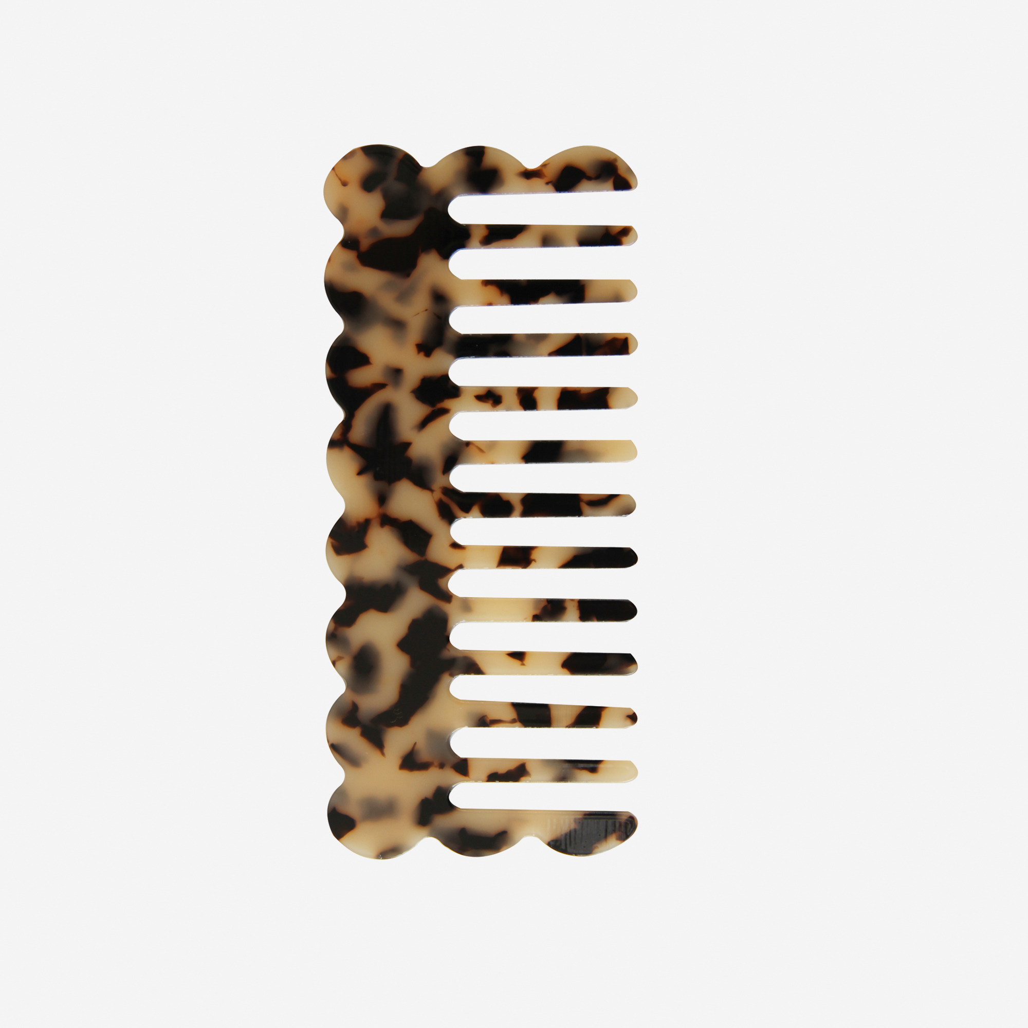 Scalloped light tortoiseshell wide tooth resin hair comb that's great for detangling and styling