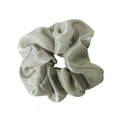 Green scrunchie on a white background