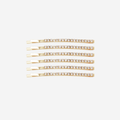 Set of 6 crystal and gold hair slides on an off white background