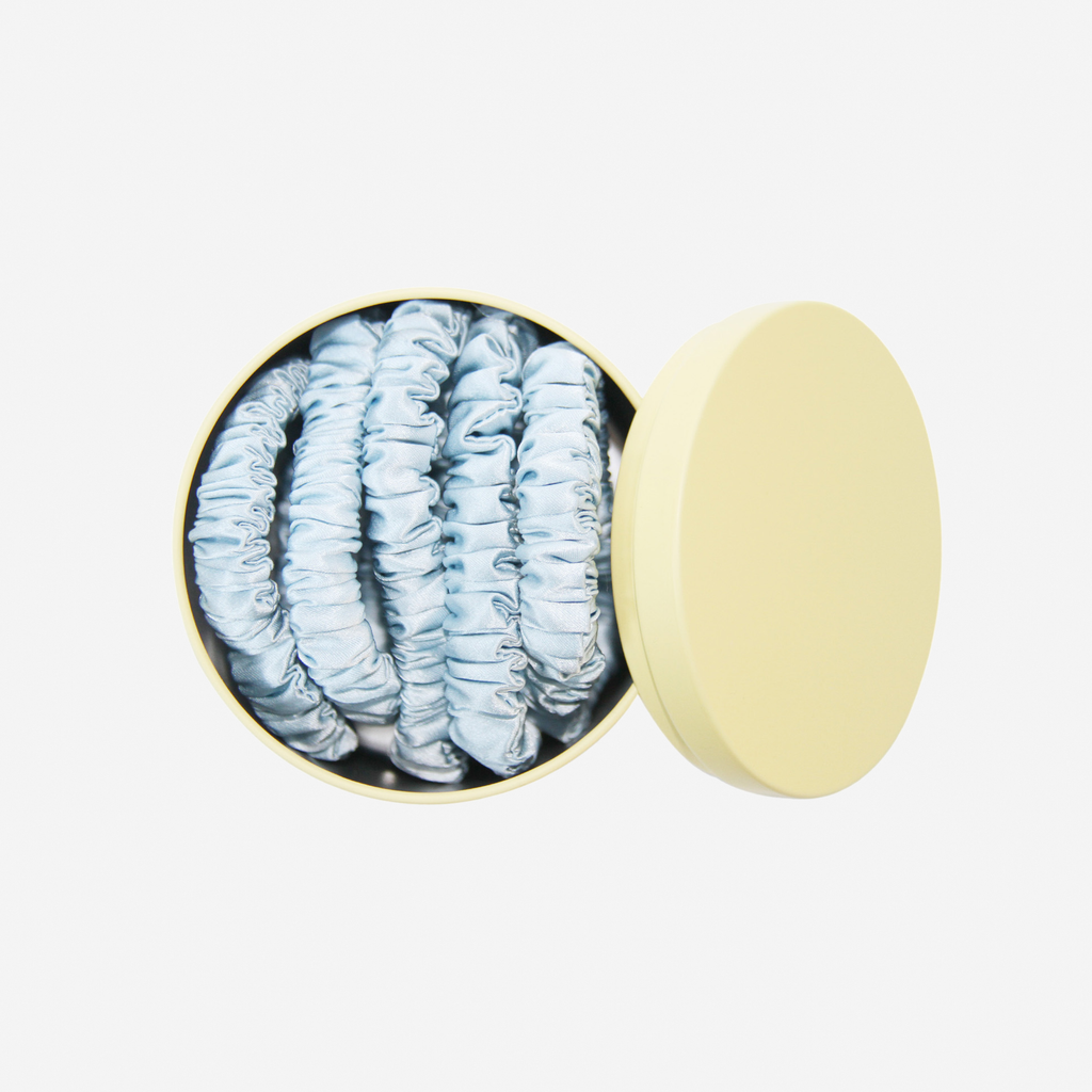 Set of 5 blue silk hair ties in a yellow keepsake tin, that they come packaged in and you can store them in, a great gift