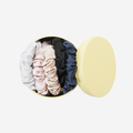 Set of 5 different colour silk scrunchies (silver, pink, champagne, black, navy blue) in a yellow keepsake tin, that they come packaged in and you can store them in, a great gift