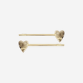 Set of 2 two gold heart hair slides on an off white background