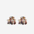 Set of 2 small multi coloured hair claws on an off white background