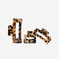 Set of 3 rectangle light tortoiseshell resin hair claws on an off white background