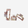 Set of 3 rectanglepink and purple resin hair claws on an off white background