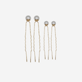 Set of 4 gold and pearl hair pins, 2 large size, 2 small size on an off white background