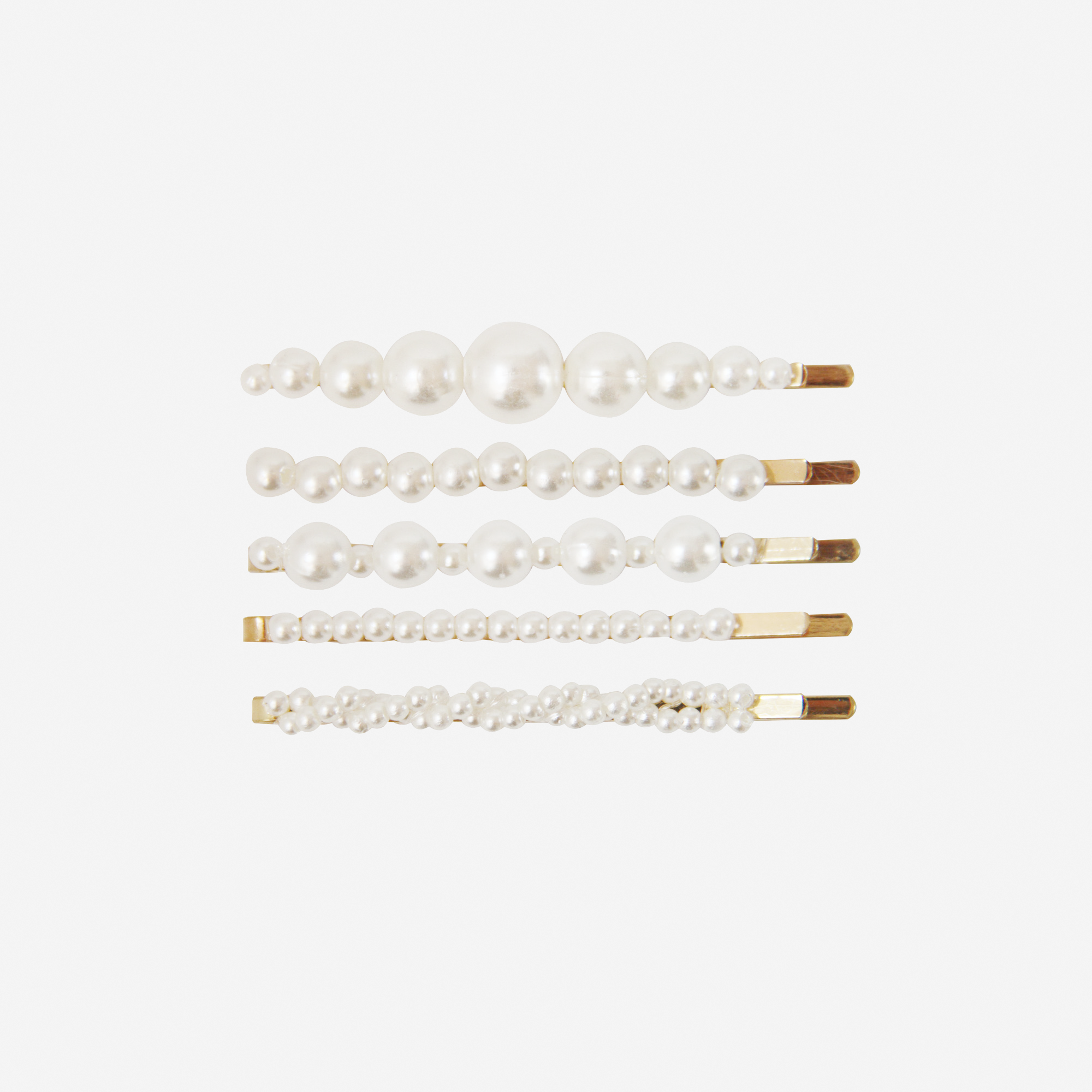 Set of 5 pearl and gold hair slides, all 5 have a different design, on an off white background