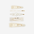 Set of 5 pearl hair clips, all have have a different design, on an off white background