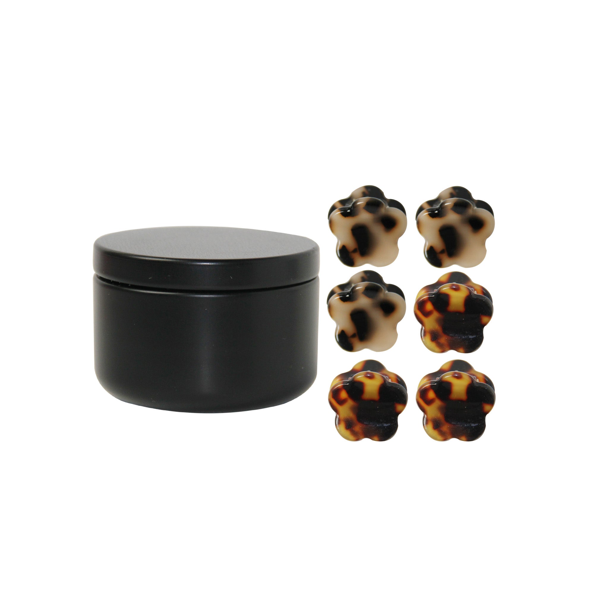 set of 6 mini tortoiseshell hair claws next to the black tin they come in on a white background