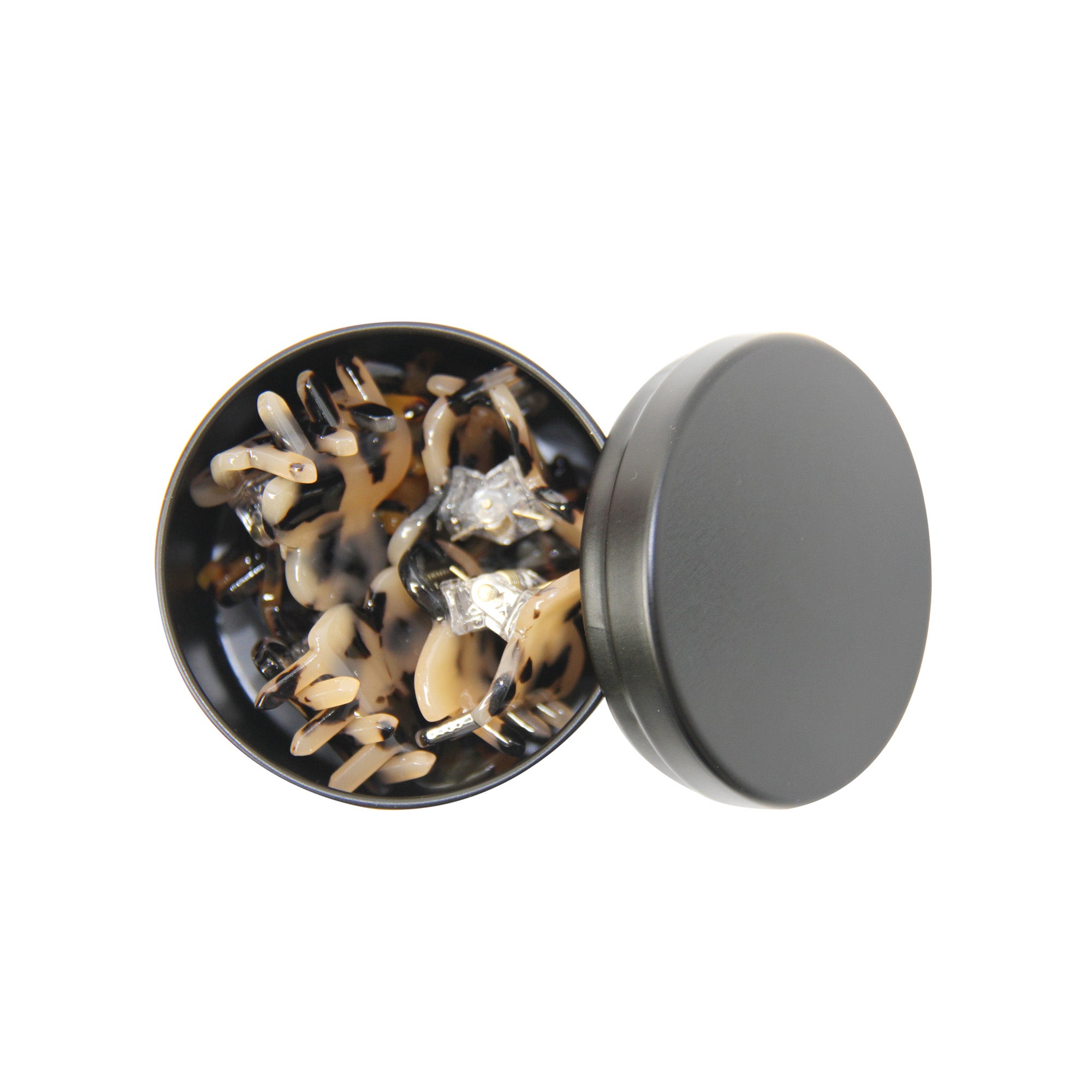 set of 8 mini tortoiseshell hair claws in an open black tin on a white background