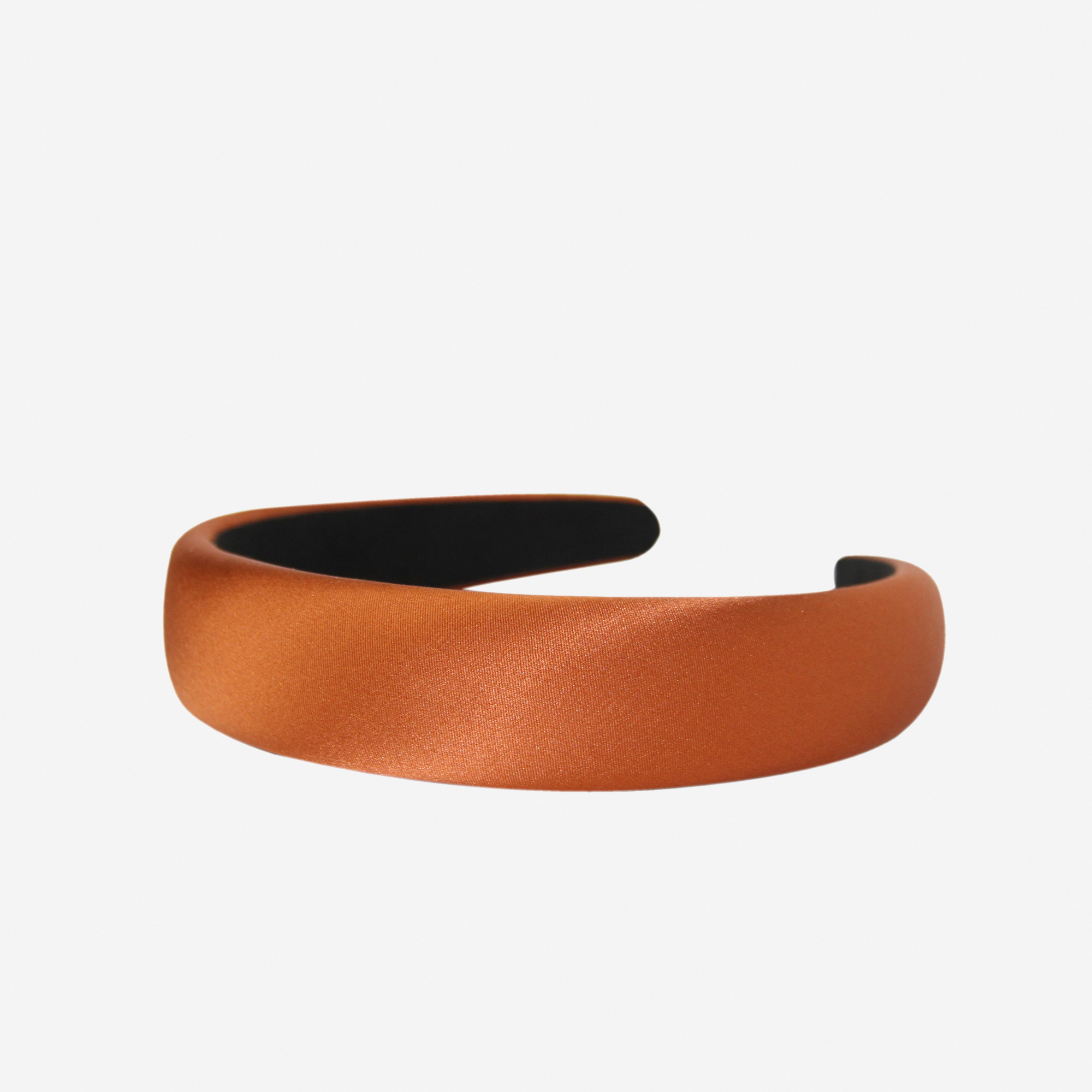 Copper silk padded headband on an off white background