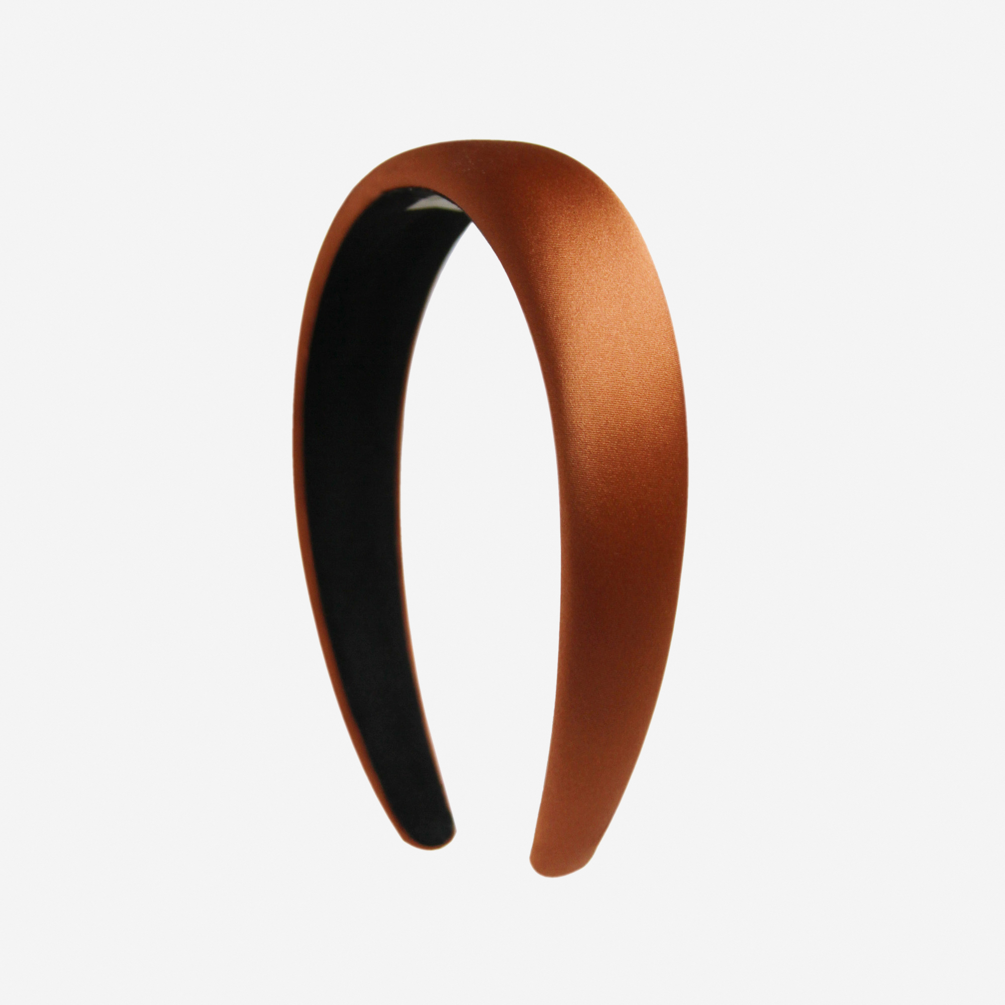Copper silk padded headband on an off white background